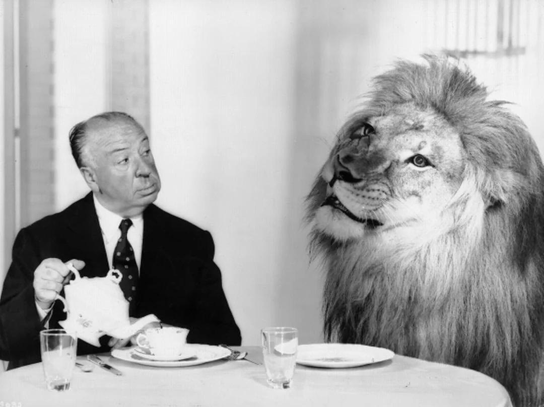 Alfred Hitchcock has dinner with MGM's Leo the Lion 1958