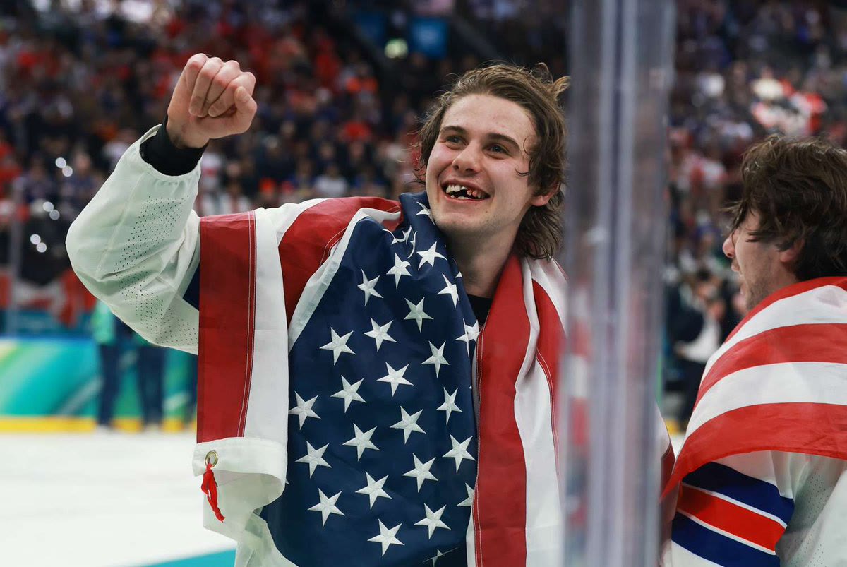 American hockey player Jack Hughes celebrating Team USA's gold medal victory at the 2026 Winter Olympics