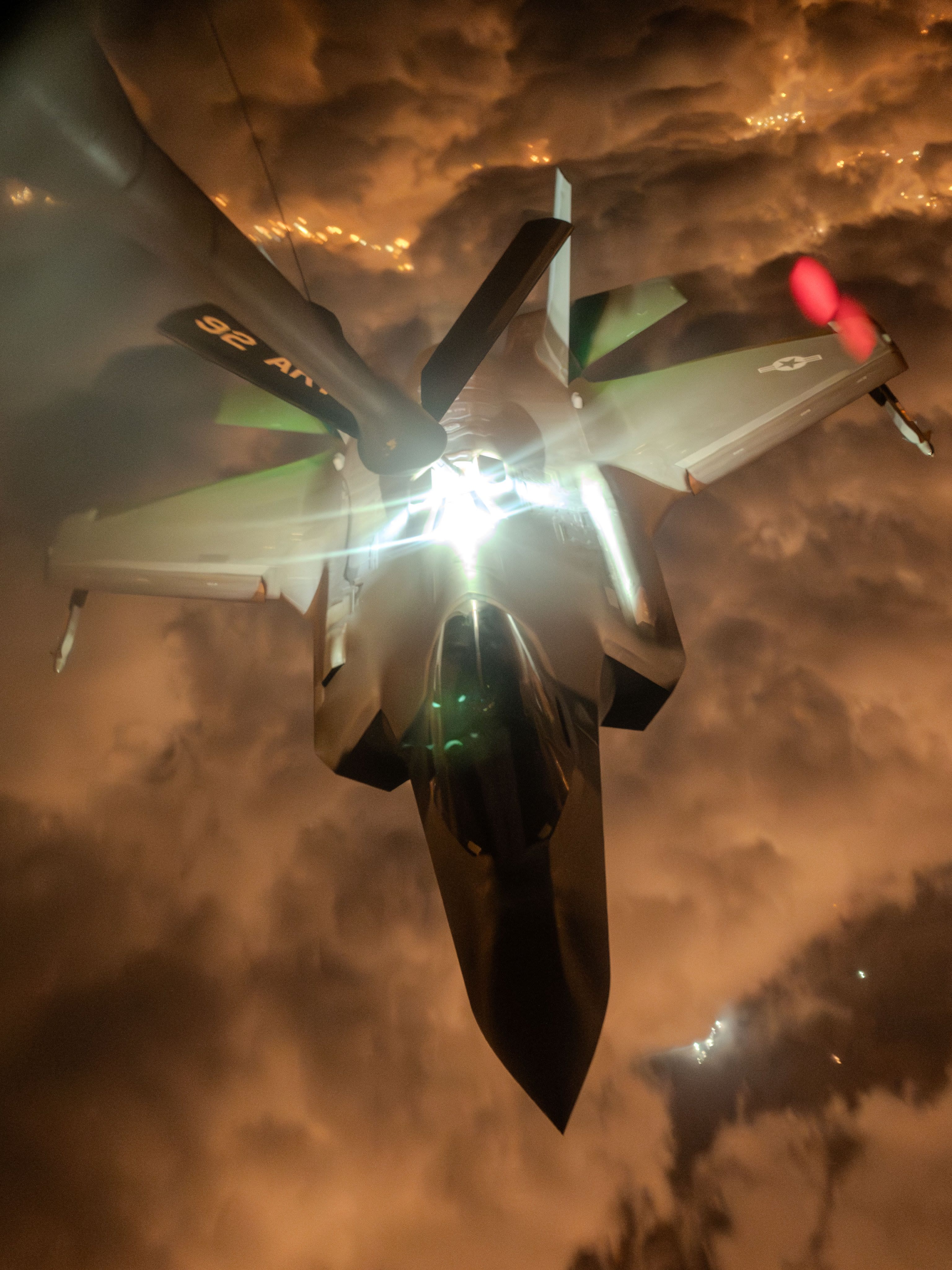 F-35A Lightning II stealth fighter conducting a nighttime aerial refueling operation