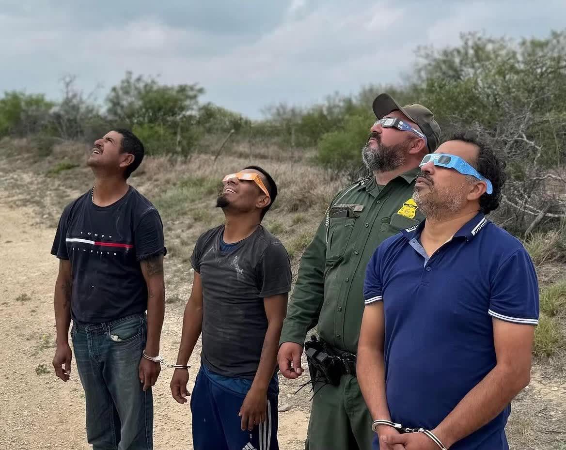 Fellas (who might've crossed the border without proper authorizations) watching the eclipse at the border