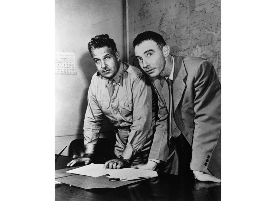 General Groves and Robert Oppenheimer looking at maps of Japan in the weeks before the deployment of the atomic bombs (from the archives of the Department of Energy)