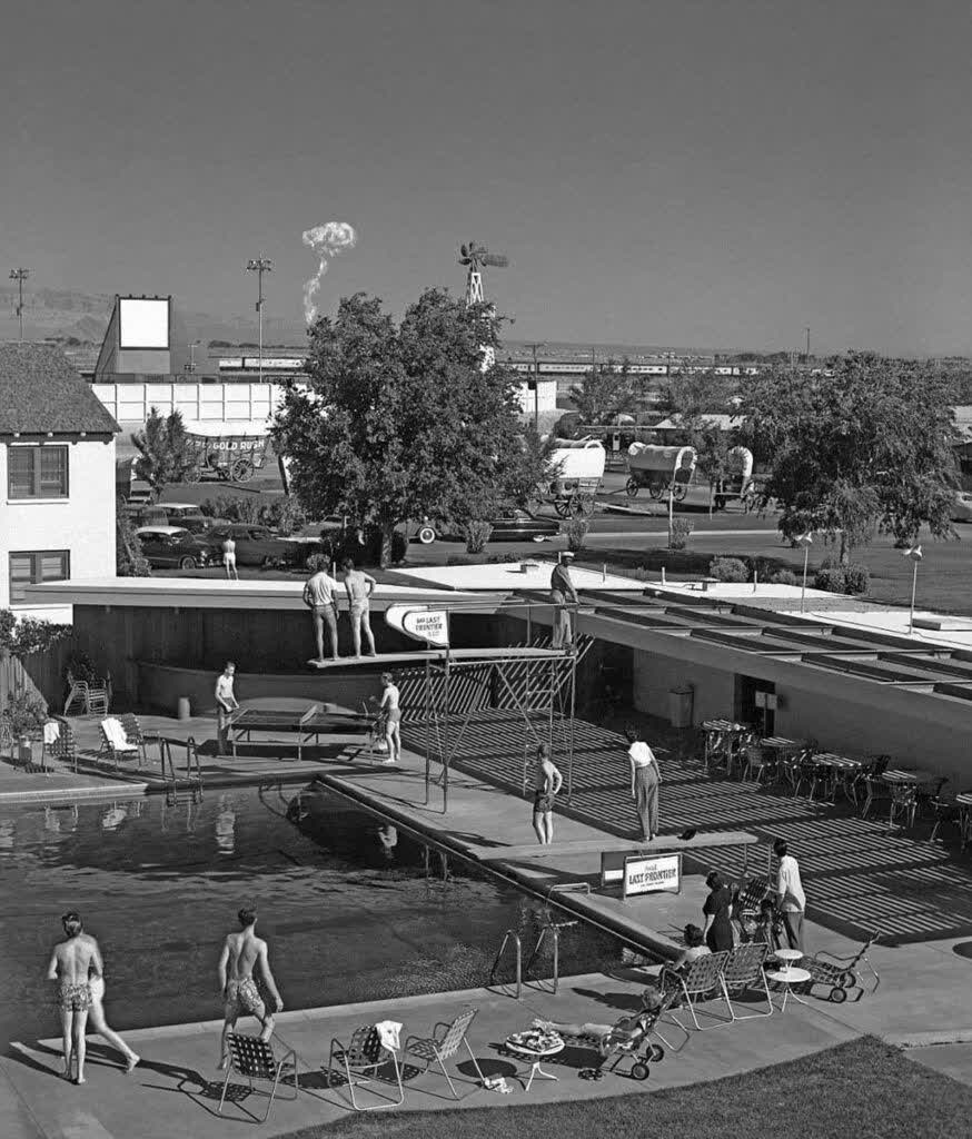 Swimmers at a Las Vegas motel watching the explosion of an atomic bomb